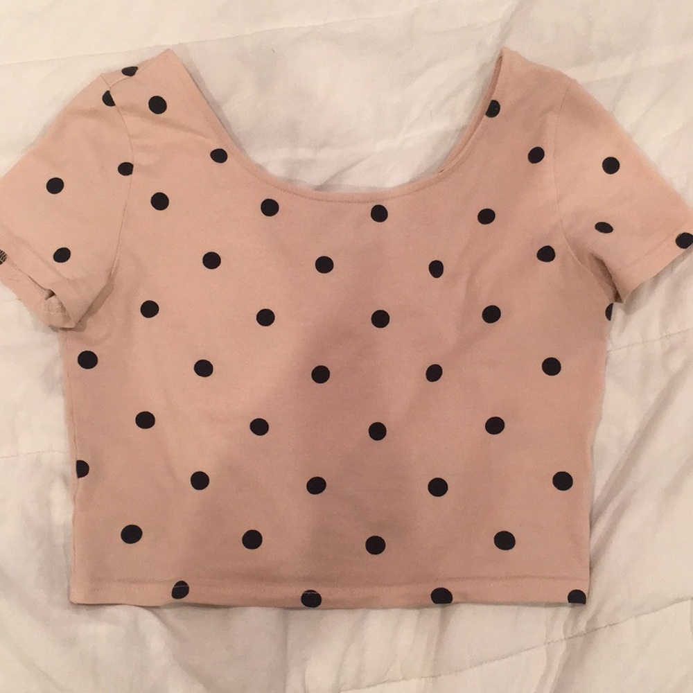 Light pink crop top with black poka dots.